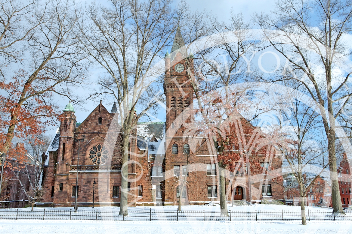 Mary Lyon Hall in winter with the College seal overlay