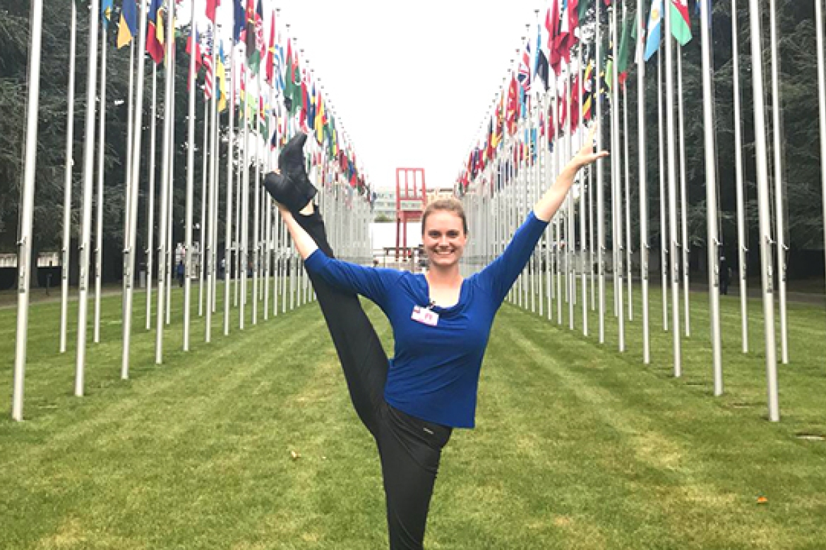 Davan O’Donnell ’19 poses amidst the flags of the members of the United Nations, outside the UN headquarters in Geneva. O’Donnell and Javeria Kella ’19 (not pictured) are earning master’s degrees in the Swiss city while they’re still undergraduates.