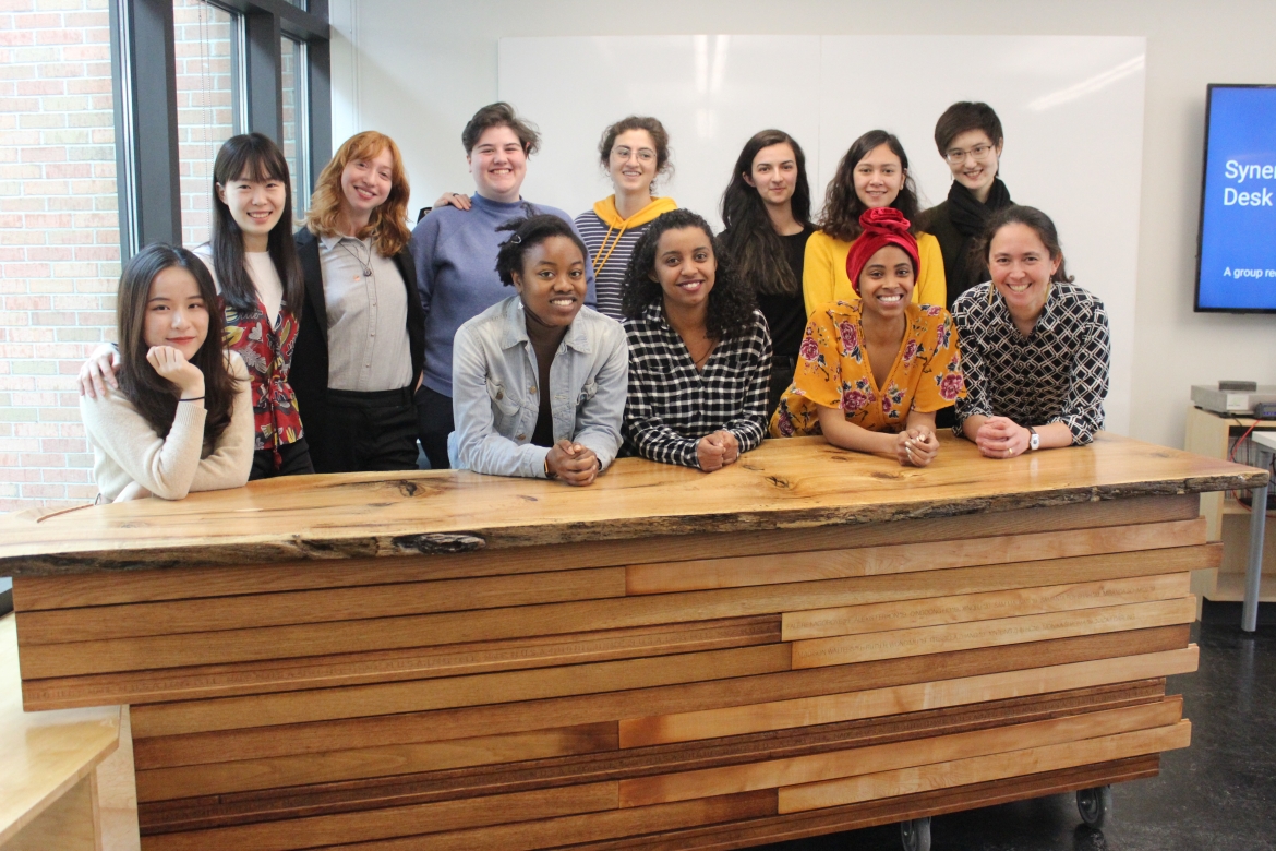 The reception desk designed and built by students (pictured left with Professor Naomi Darling, front right) in the design-build class held in the Fimbel Lab.