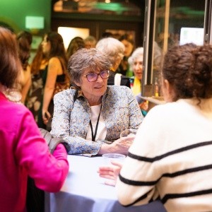 Alums meeting with students at a reception