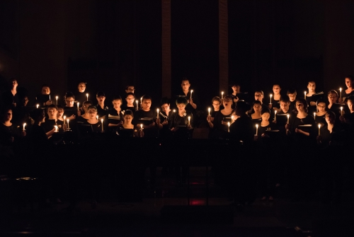 Large group choral performance by candlelight