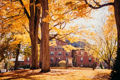 Porter Hall seen through leaves covered in fall foliage
