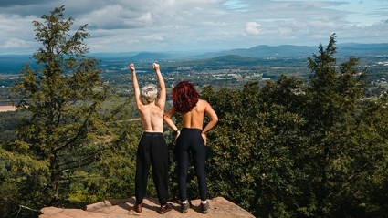 Topless students take in the view of the valley on Mountain Day.