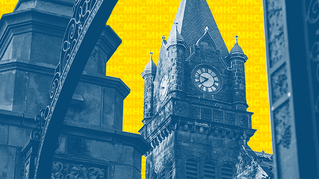 Mount Holyoke iconic gates, with the clock tower in the background.