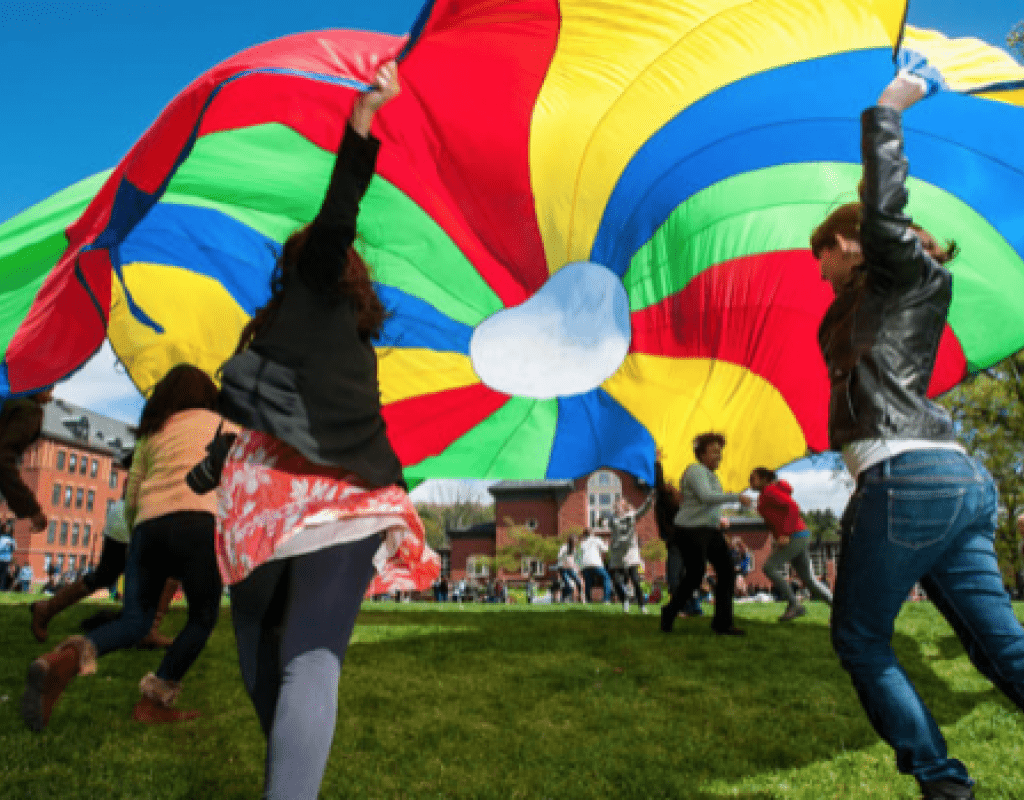 Students having fun with a colorful parachute on Pangy Day