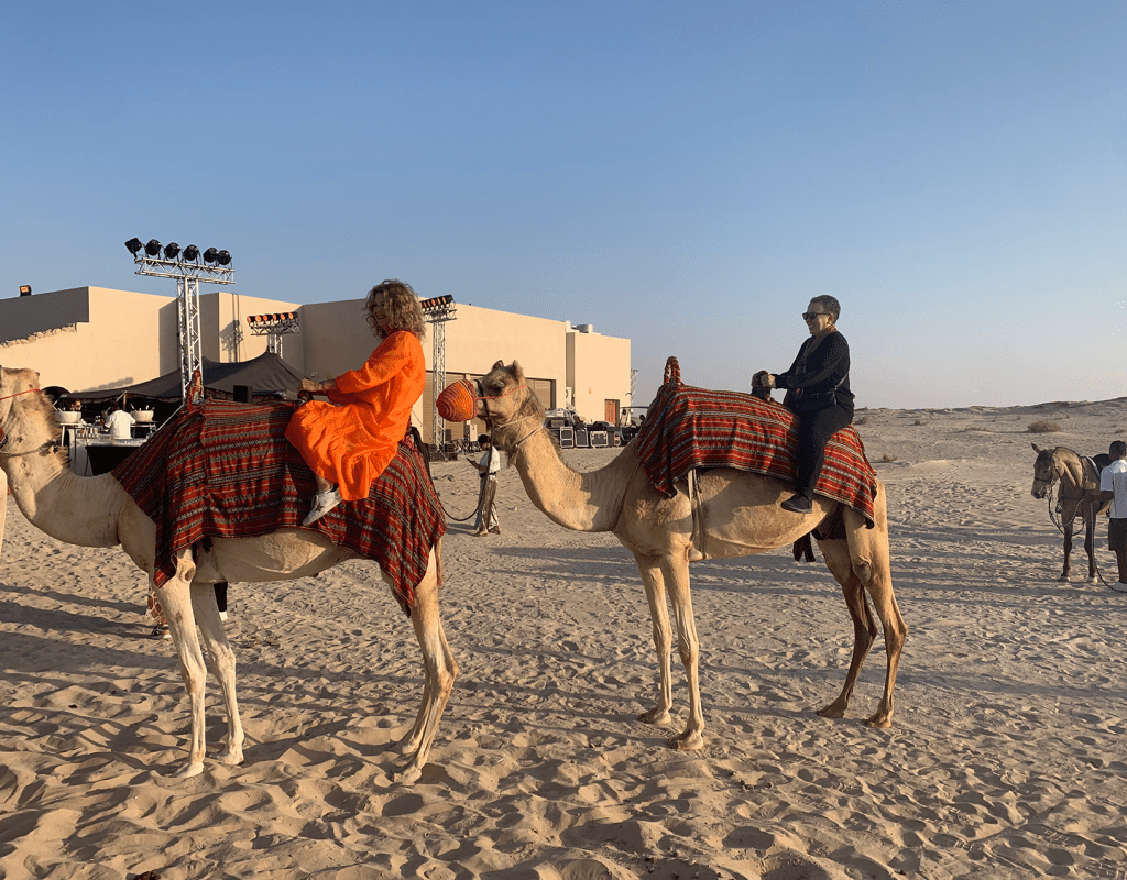 Interim President Tatum riding a camel in the Al Wathba Desert