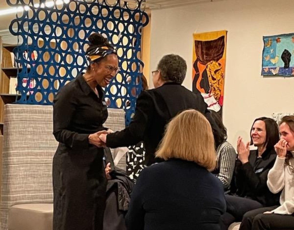 Dr. Beverly Daniel Tatum is greeted as she makes her way to the front of the room.