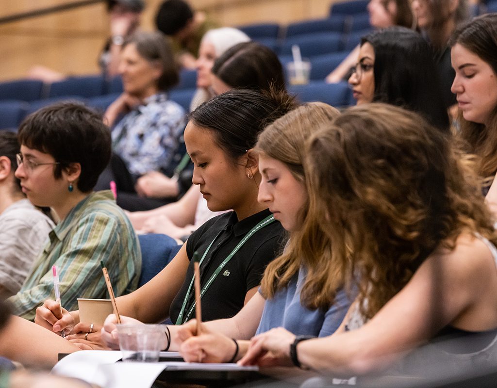 MWCE Climate Justice Summit audience taking notes.