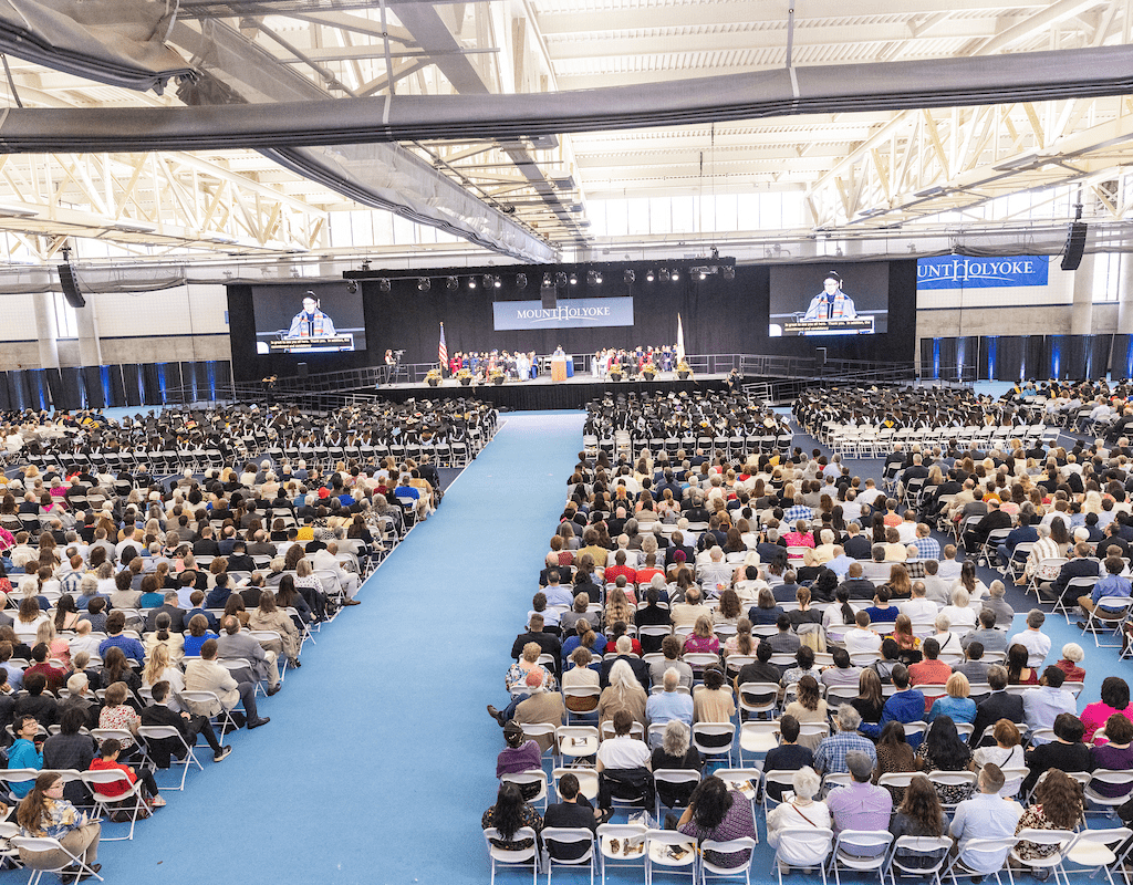 A view from the back of the room during Commencement 2023 -- the crowd and the stage