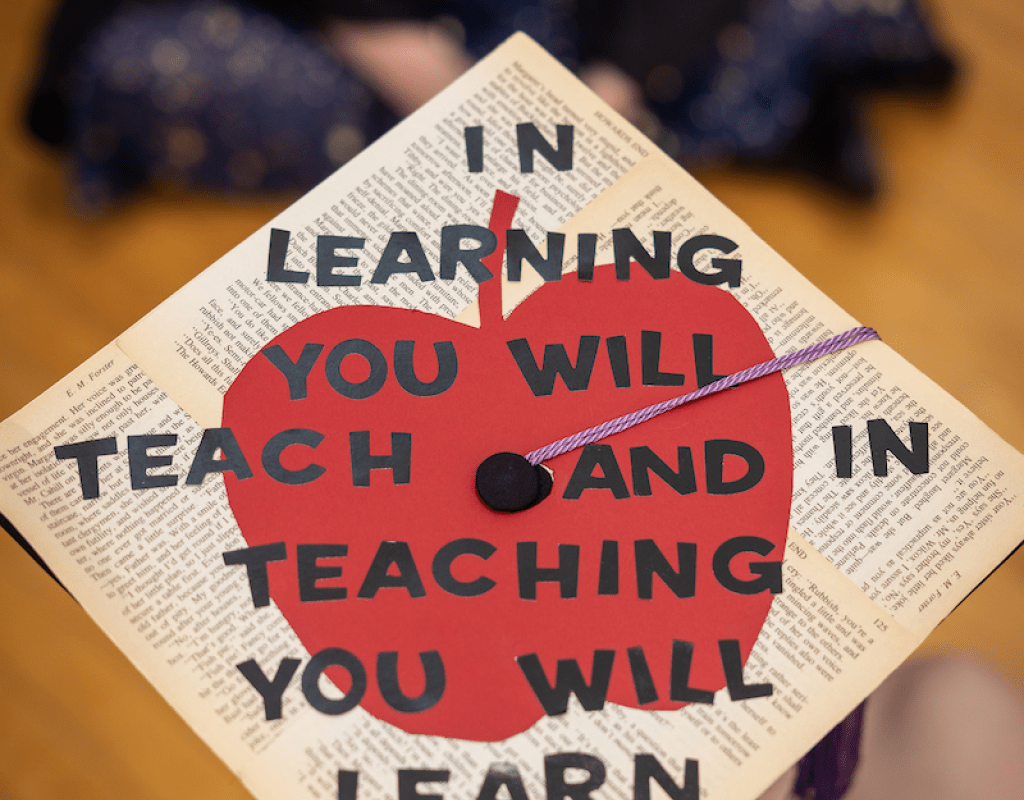 the top of a Commencement mortar board that says &quot;In learning you will teach and in teaching you will learn.&quot;