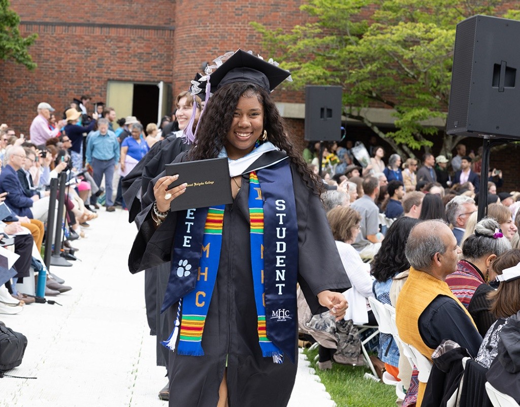 Mount Holyoke Commencement 2024 - Student in robes walks down the aisle