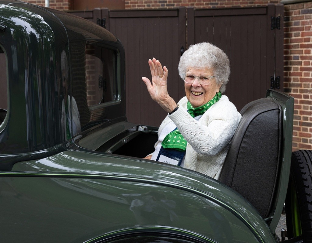 Mount Holyoke Commencement 2024 - An alum waves from the back of a car