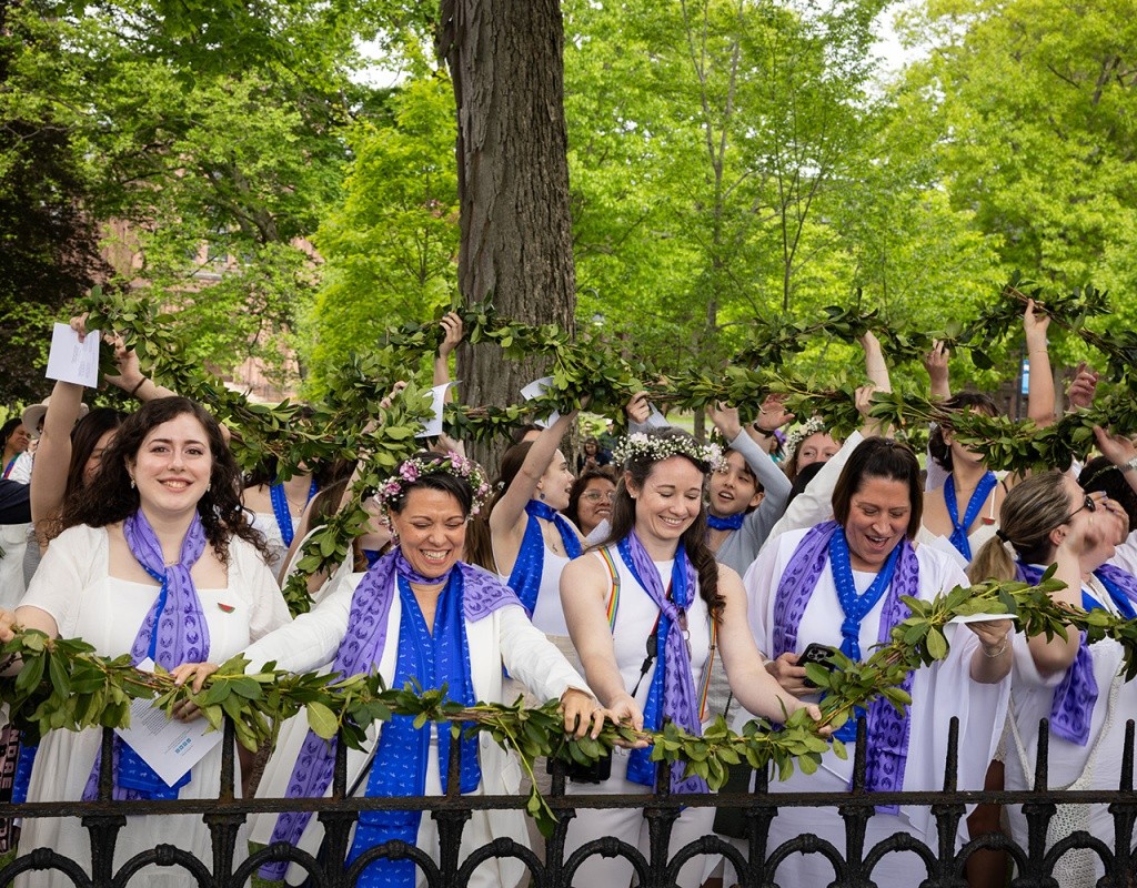 Mount Holyoke Commencement 2024 - Students drape the laurel over the iron gates at Mary Lyon's grave.