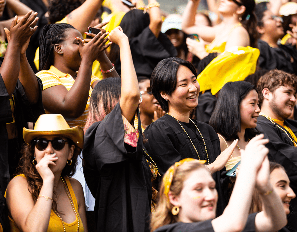 A group of seniors clapping and cheering during Convocation 2022