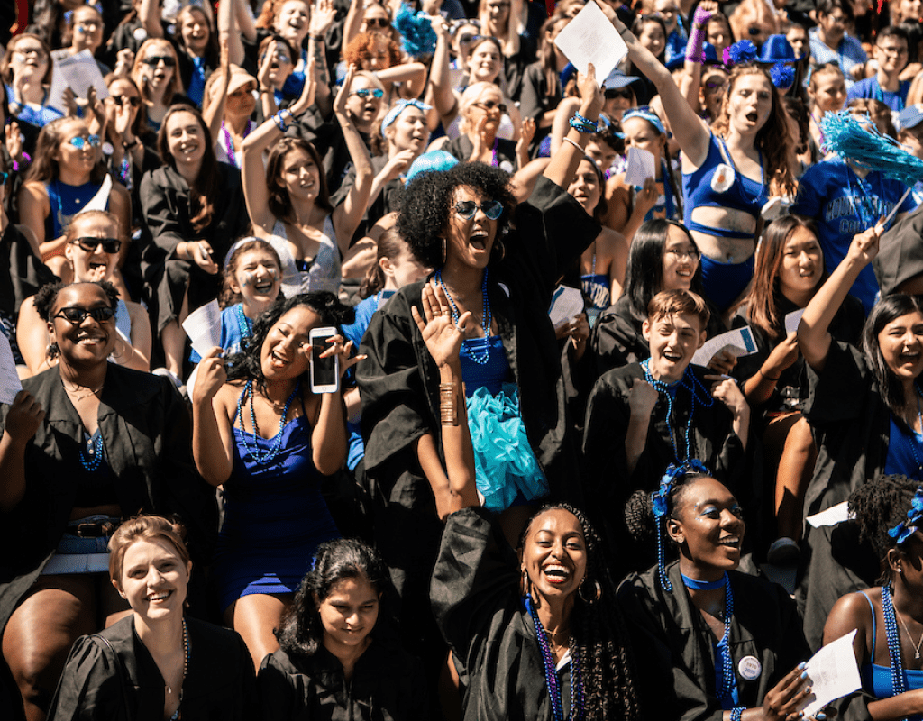 Seniors dressed in class colors under their graduation robes