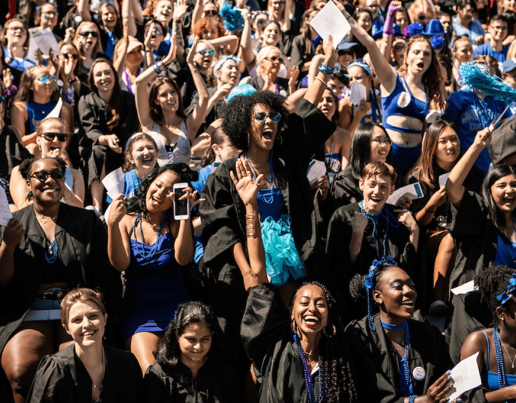 Seniors dressed in class colors under their graduation robes