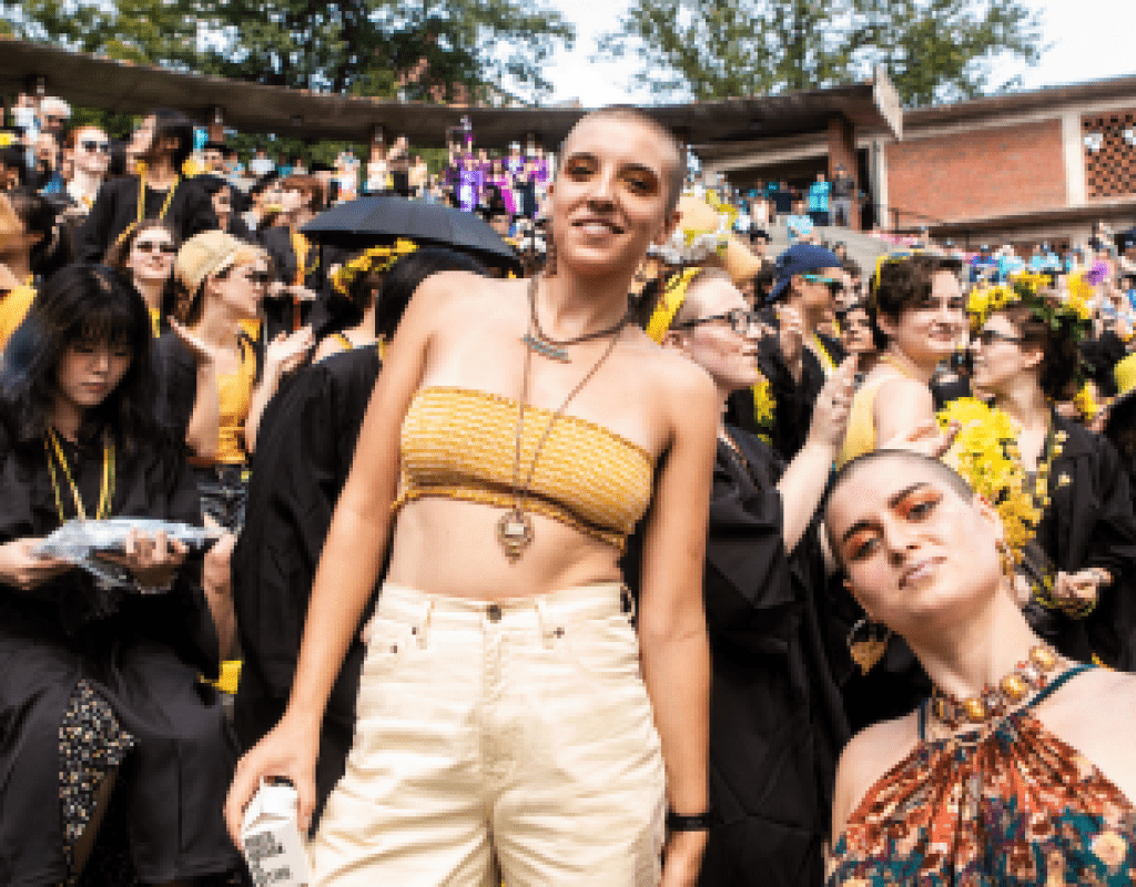 Two students displaying shaved heads as they enjoy Convocation festivities