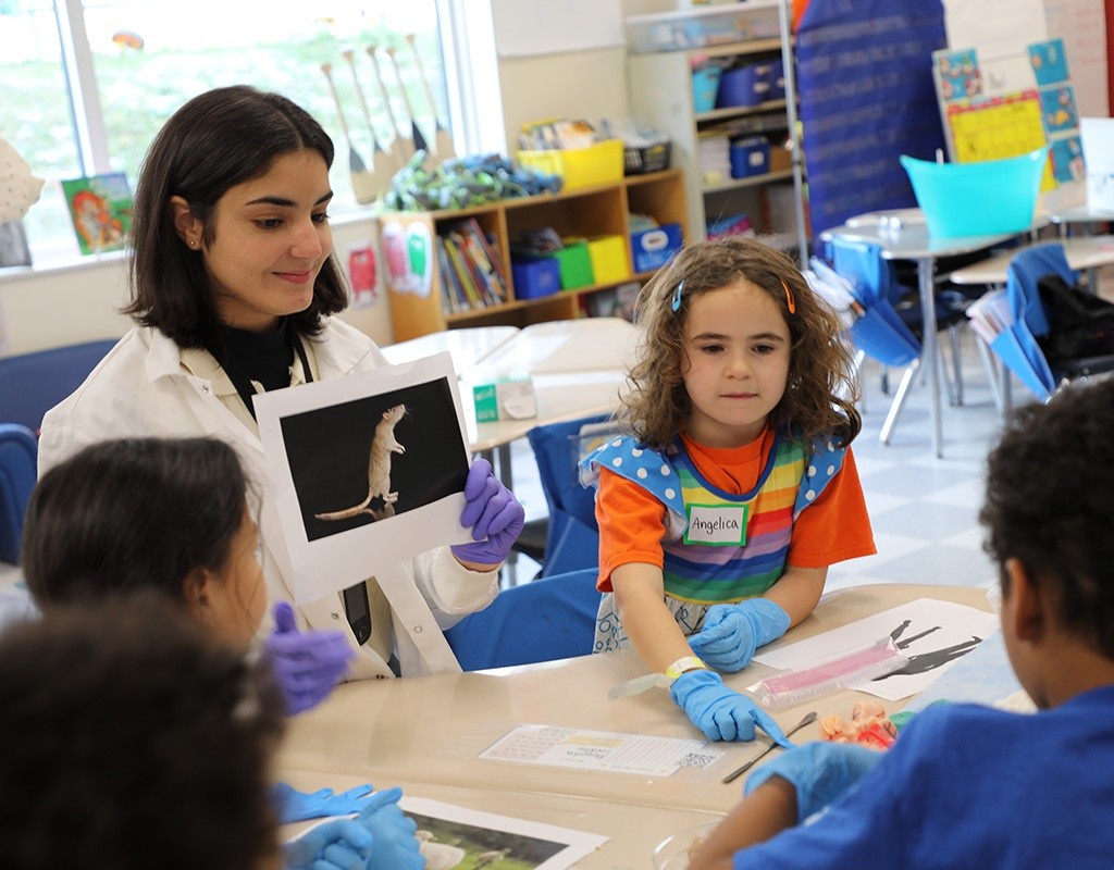 MHC student engages with first graders during a brain workshop.