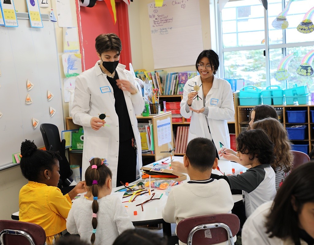 MHC students guide first graders through neuron brain craft activity.