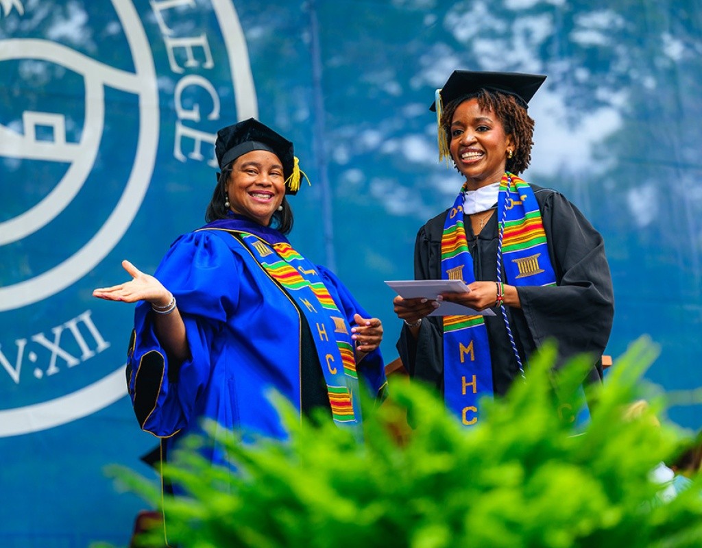 Danielle Holley on the stage with a student during Commencement 2025