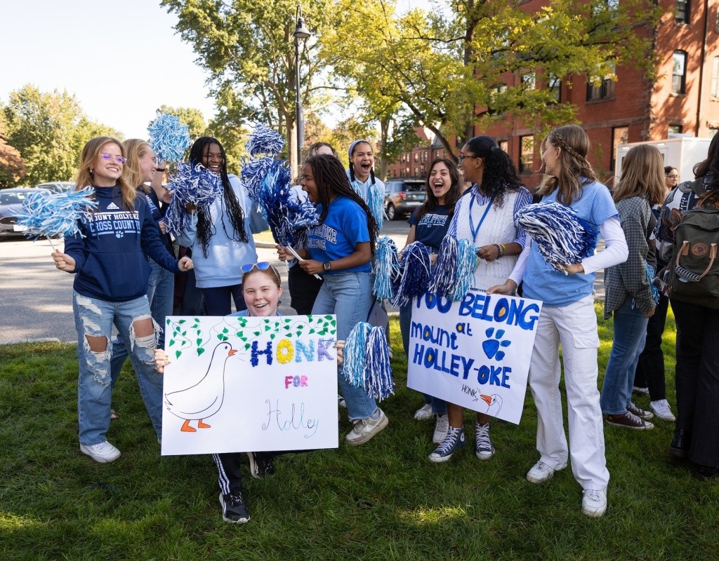 Students on Pageant Green, holding a Honk for Holley sign