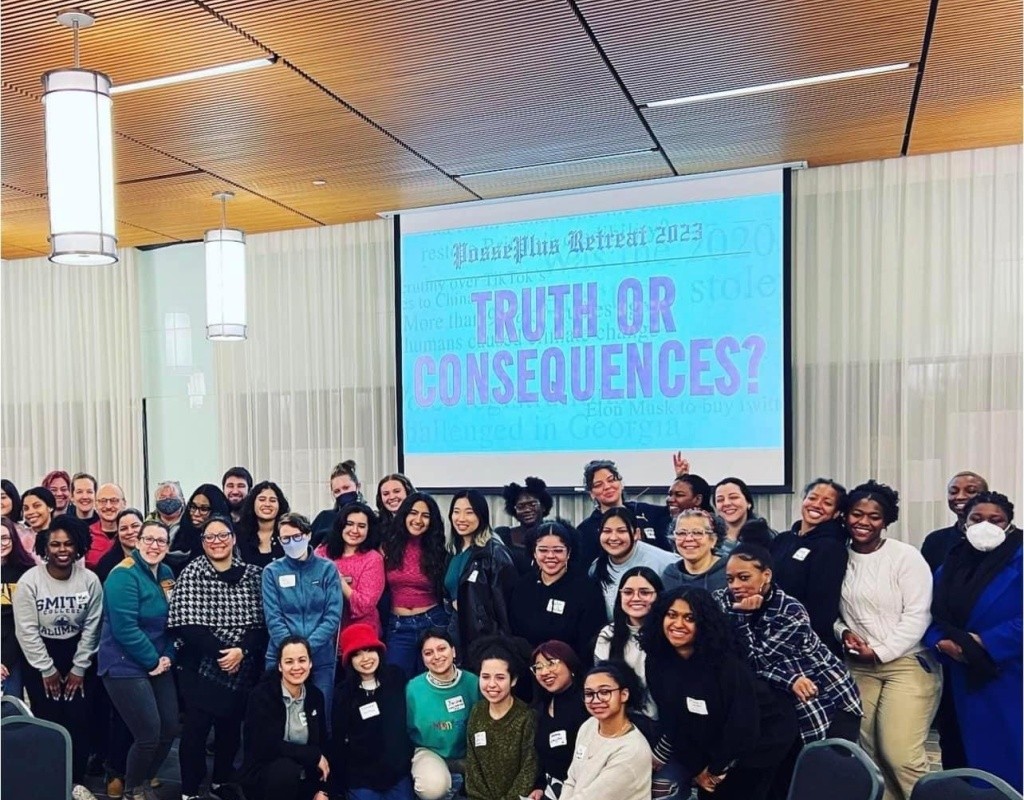 Posse scholars pose together at Posse Foundation event, Truth or Consequences on the screen behind them.