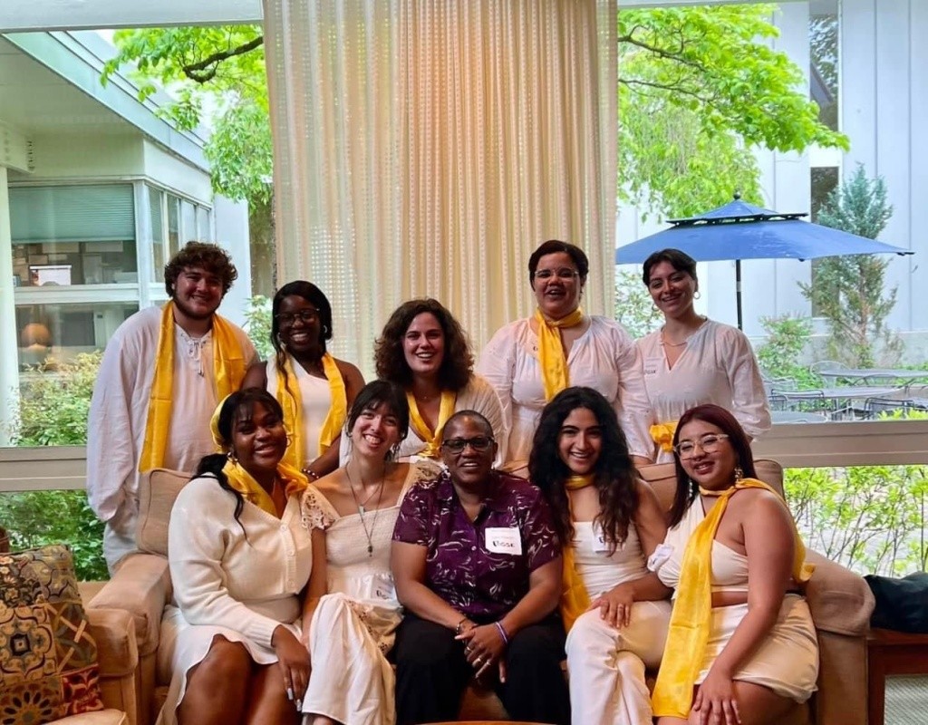 Smiling Posse scholars pose together, some seated on a couch.