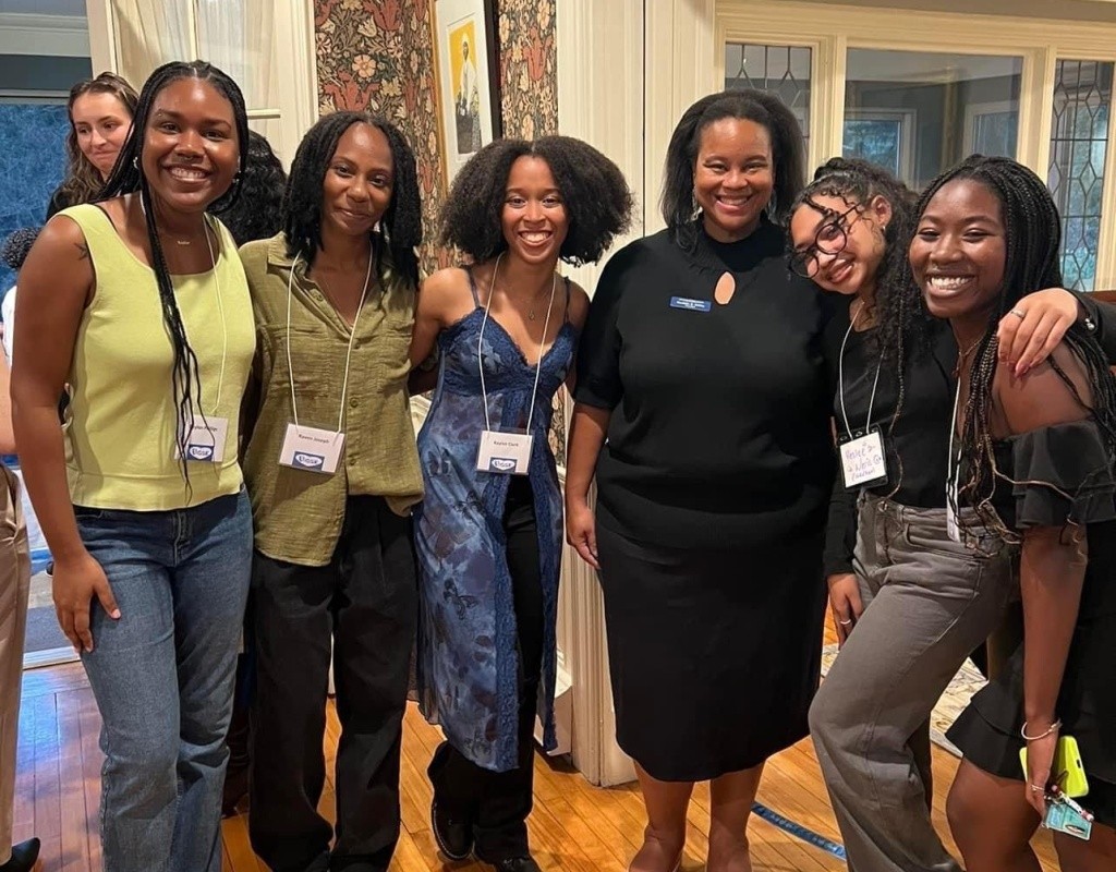 Smiling Posse scholars pose together at the President's House, Mount Holyoke.