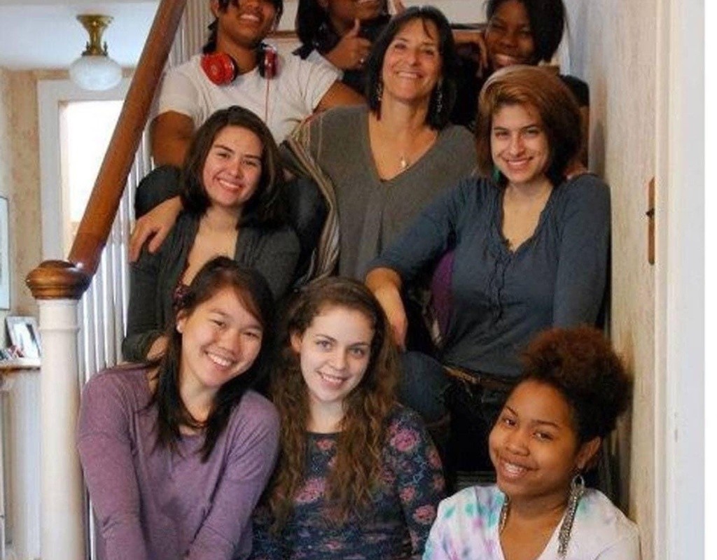 Posse scholars sit clustered together on stairs.