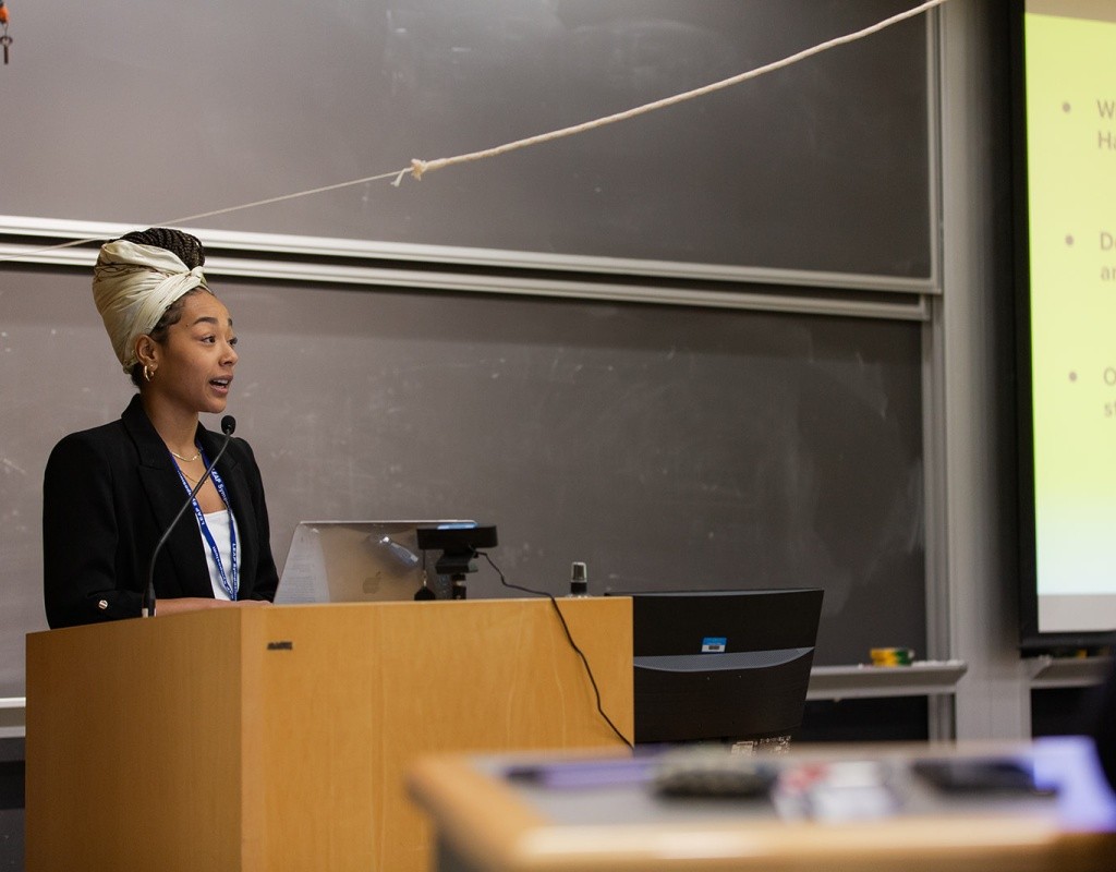 A student standing at a podium doing a presentation during LEAP Symposium 2022
