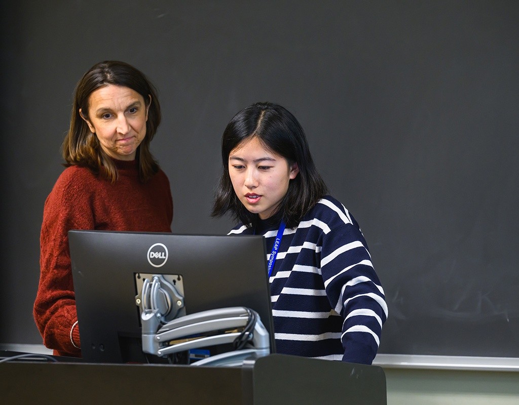 Student presenter looking at a computer screen. LEAP 2024, Mount Holyoke College