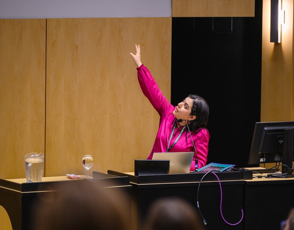 Speaker points to a screen at the Summit on Feminist Leadership in Climate Justice held at Mount Holyoke College on April 25, 2025