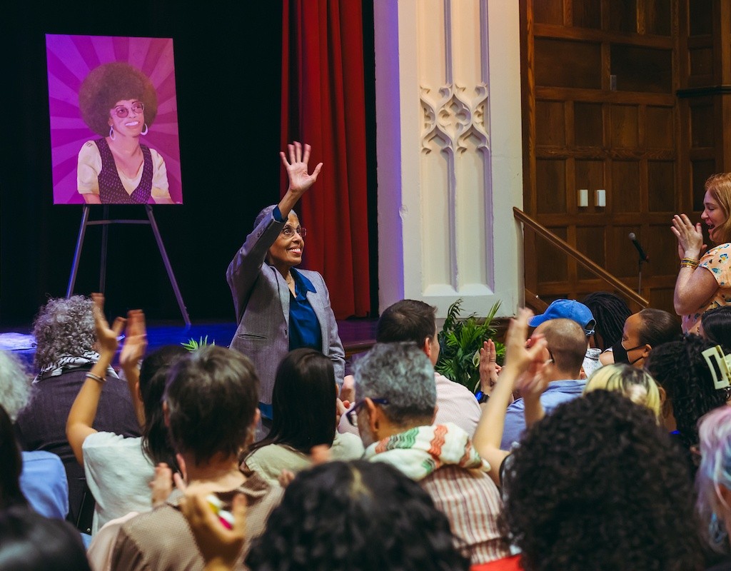 Barbara Smith stands to applause during the Angela Y. Davis presentation.