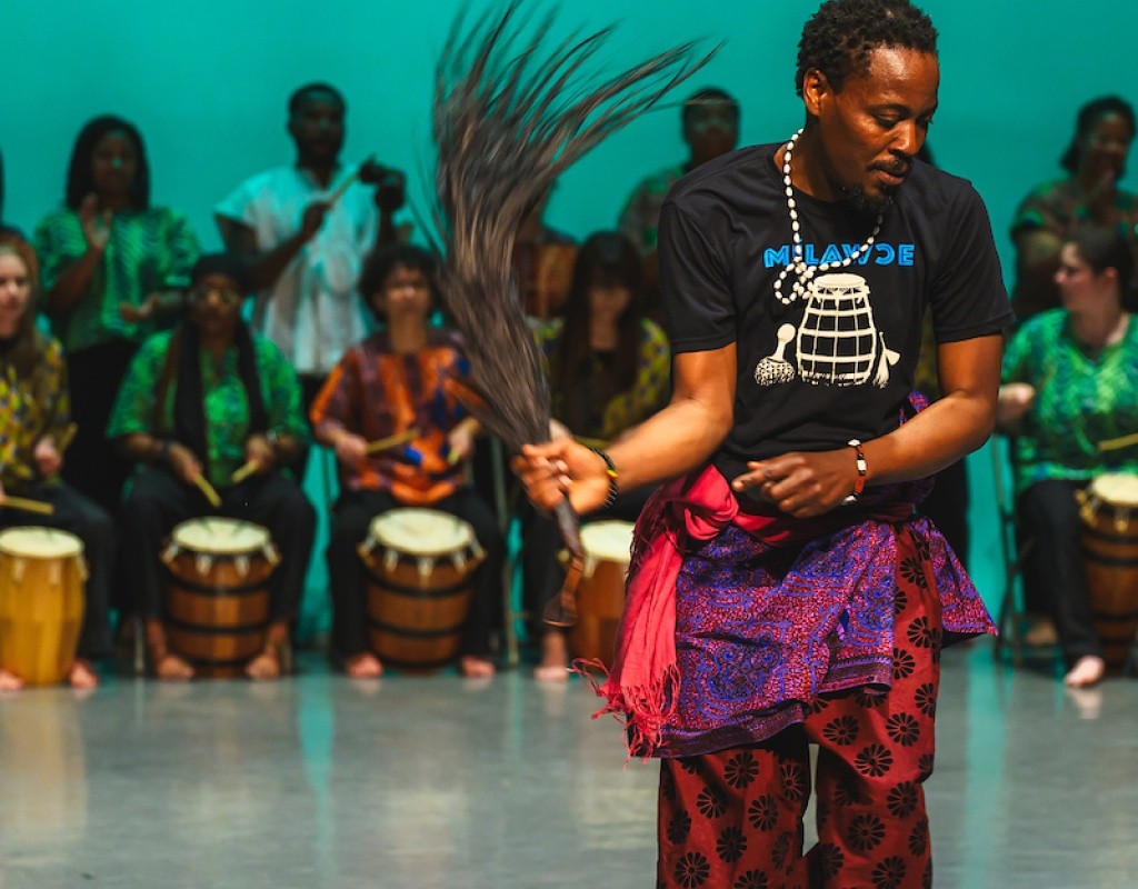 Dance on stage during the AGOO! concert — a night of West African music and dance.