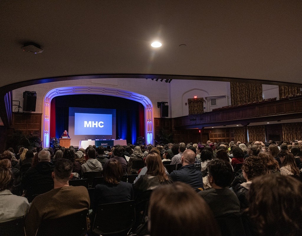 Chapin Auditorium packed with people and a presentation on the screen at Experience MHC! April 5, 2025, Photo by Jo Chattman.