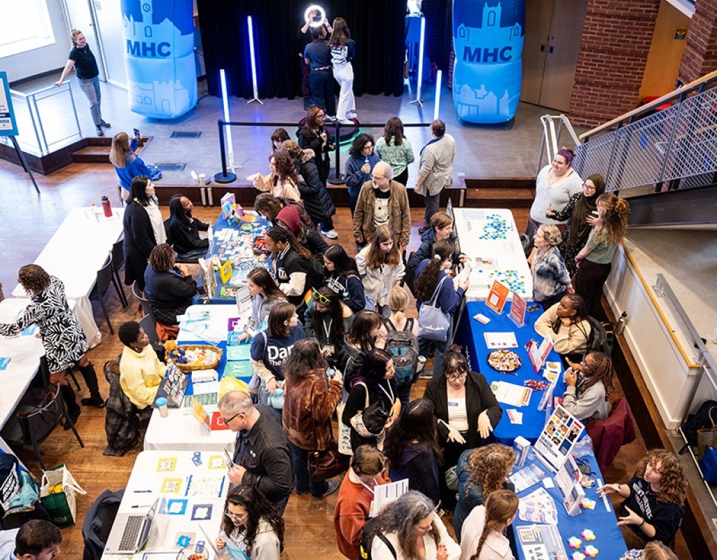 Overhead shot of the community tables and the Mount Holyoke College archway at Experience MHC! Photo by Jo Chattman.