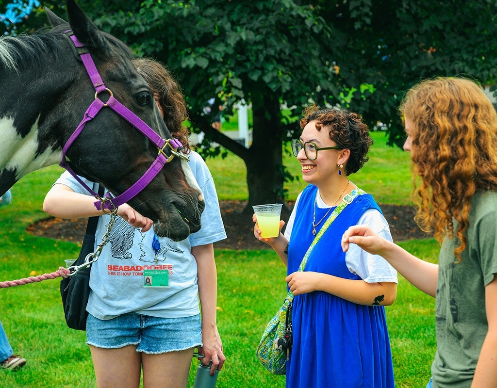 Mount Holyoke College New Student Orientation - Students greeting a horse