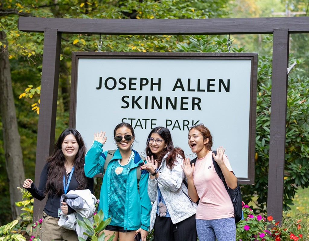 Mount Holyoke students pose in front of the Joseph Allen Skinner State Park sign