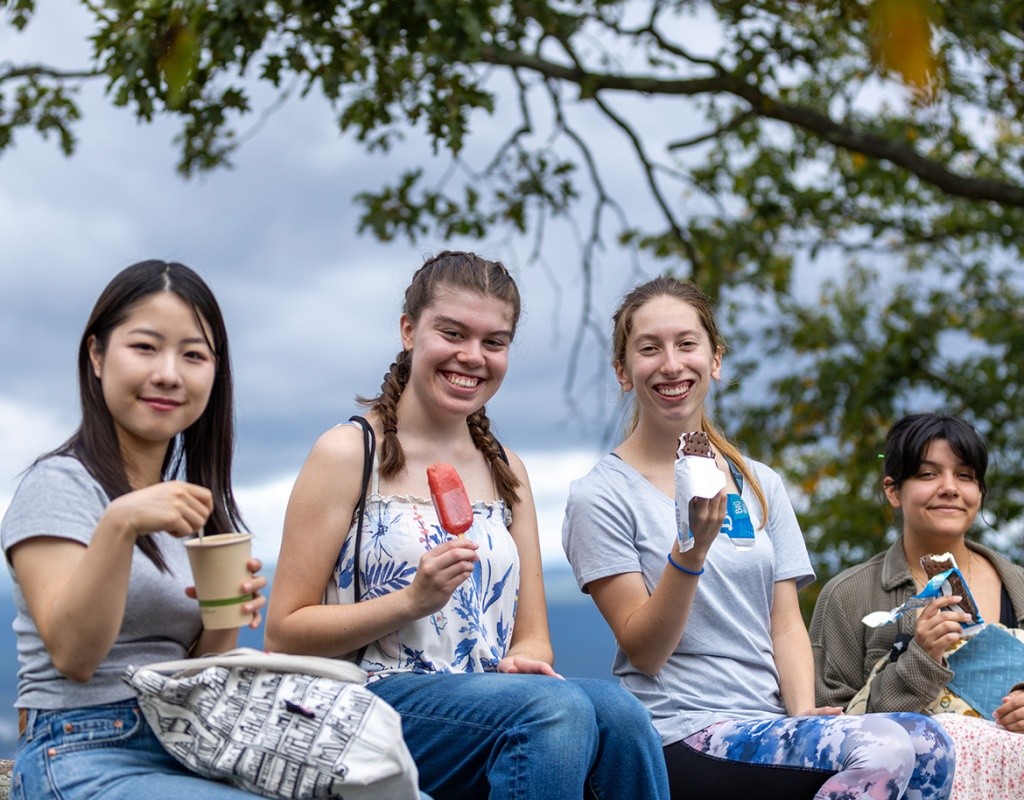 Students sit atop Mt. Holyoke with ice cream treats.