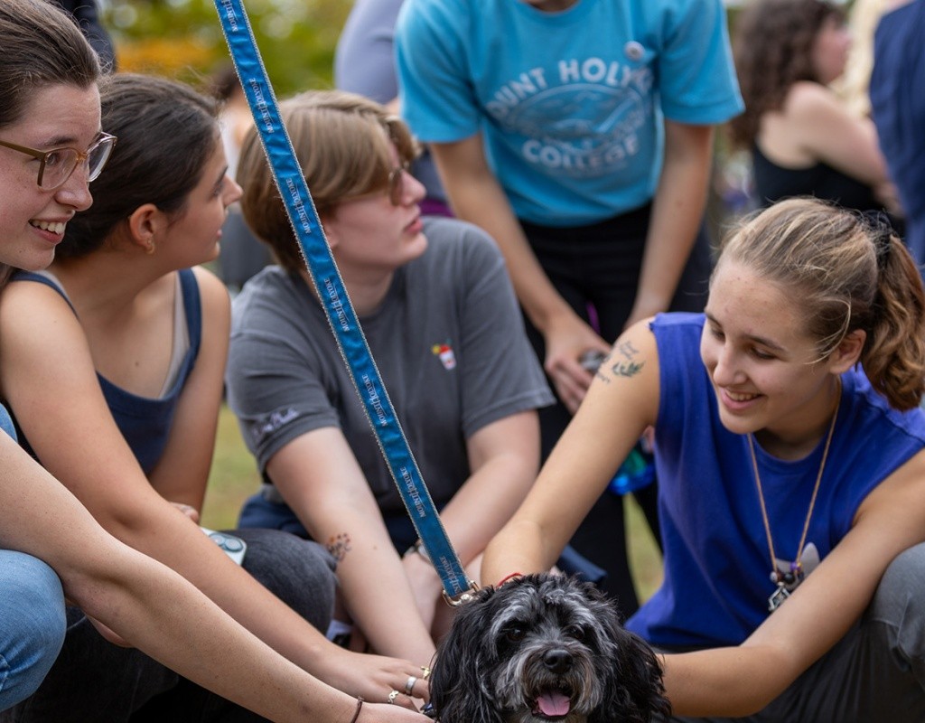 Blu, President Holley's dog, enjoying some pets from Mount Holyoke College students during Mountain Day