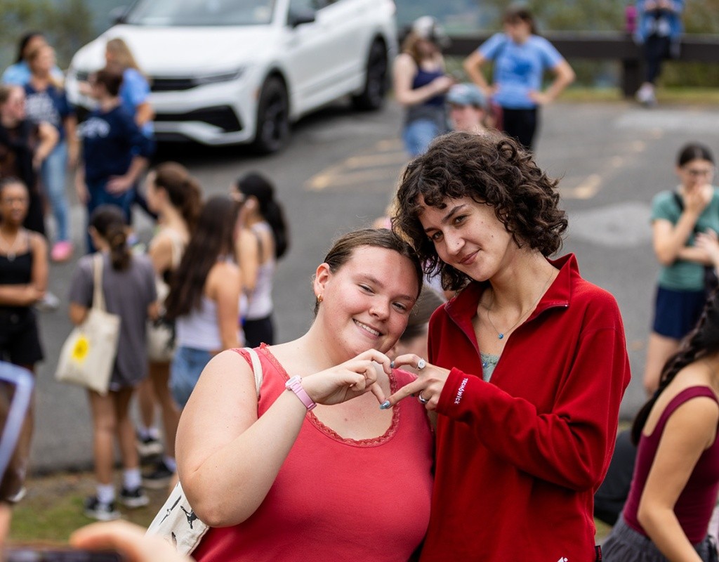Mount Holyoke students make a heart with their hands