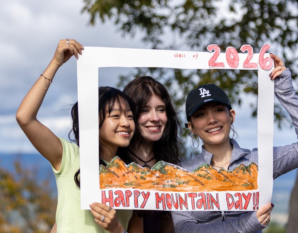 Students holding up a frame on Mt. Holyoke