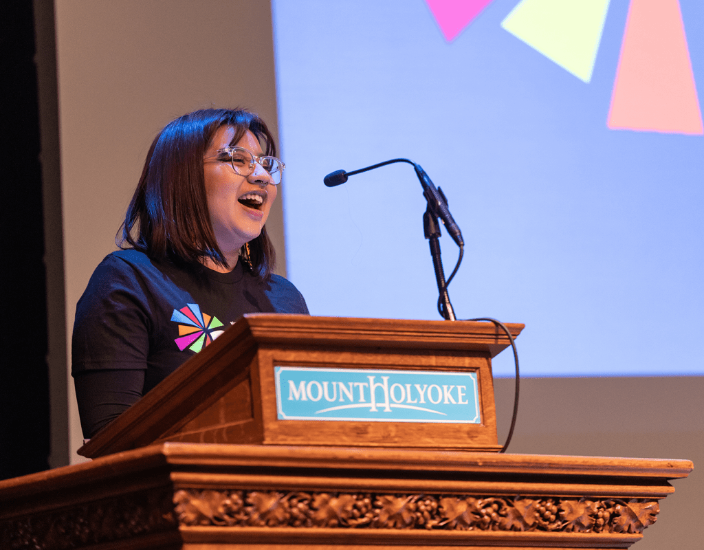 A student addresses the audience from the podium during the 2023 BOOM! Learning Symposium