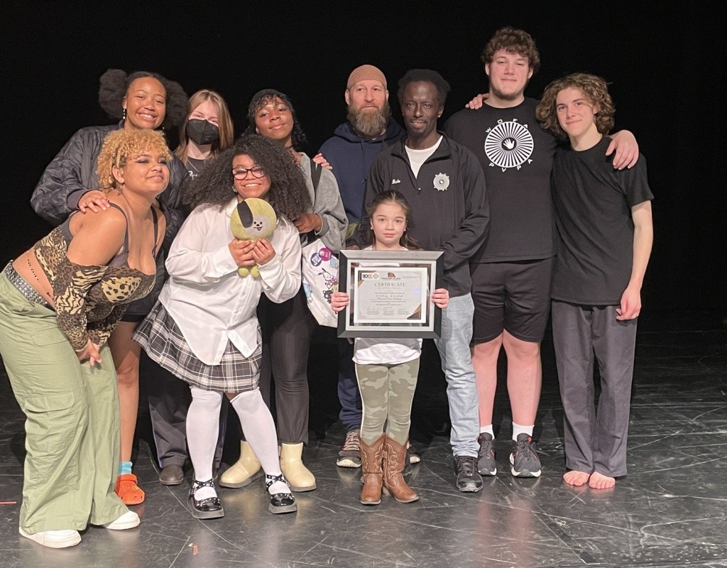 TOCLC Attendees pose together on stage holding certificate.