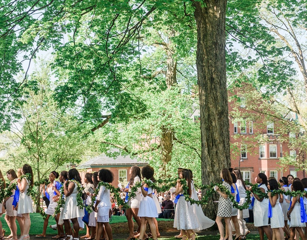 Students circle Mary Lyon's grave before draping the laurel on the fence