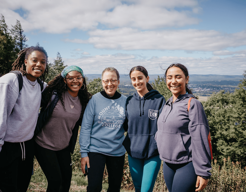 Students enjoying the view from the summit of Mount Holyoke with Interim President Beverly Daniel Tatum (center)