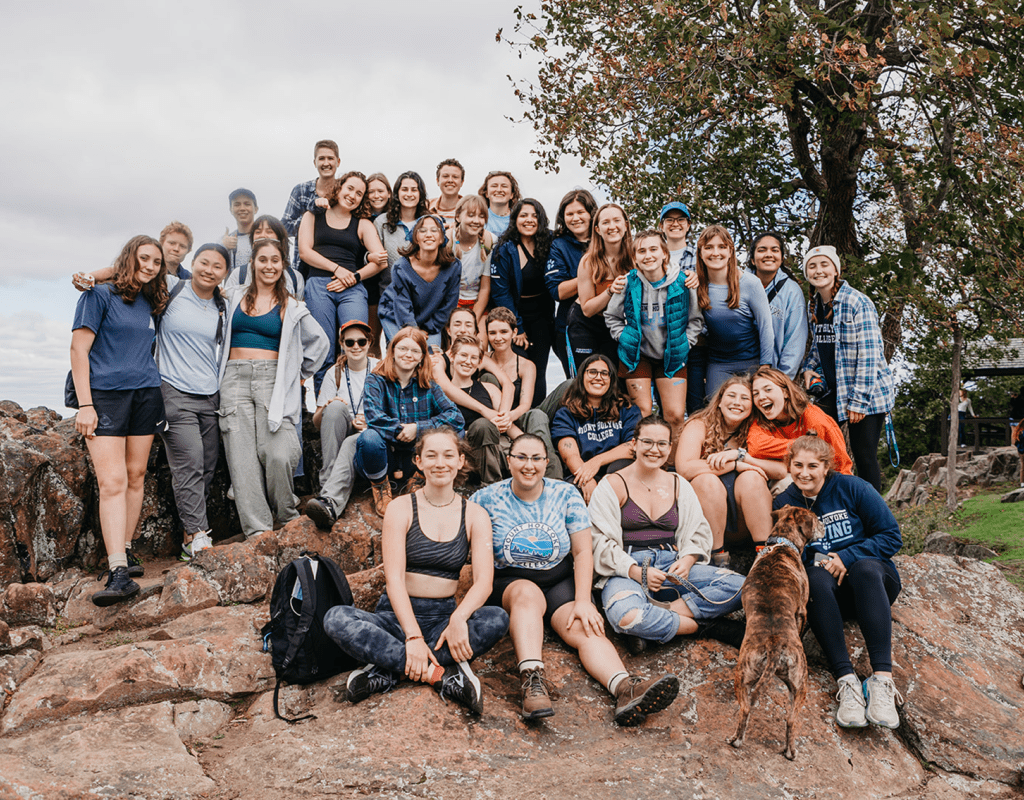 Groups large and small gather at the summit for photos to celebrate Mountain Day