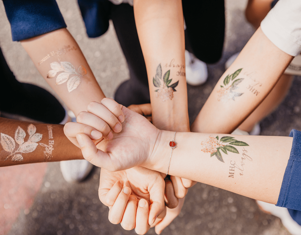 Students showing off their Mountain Day tattoos