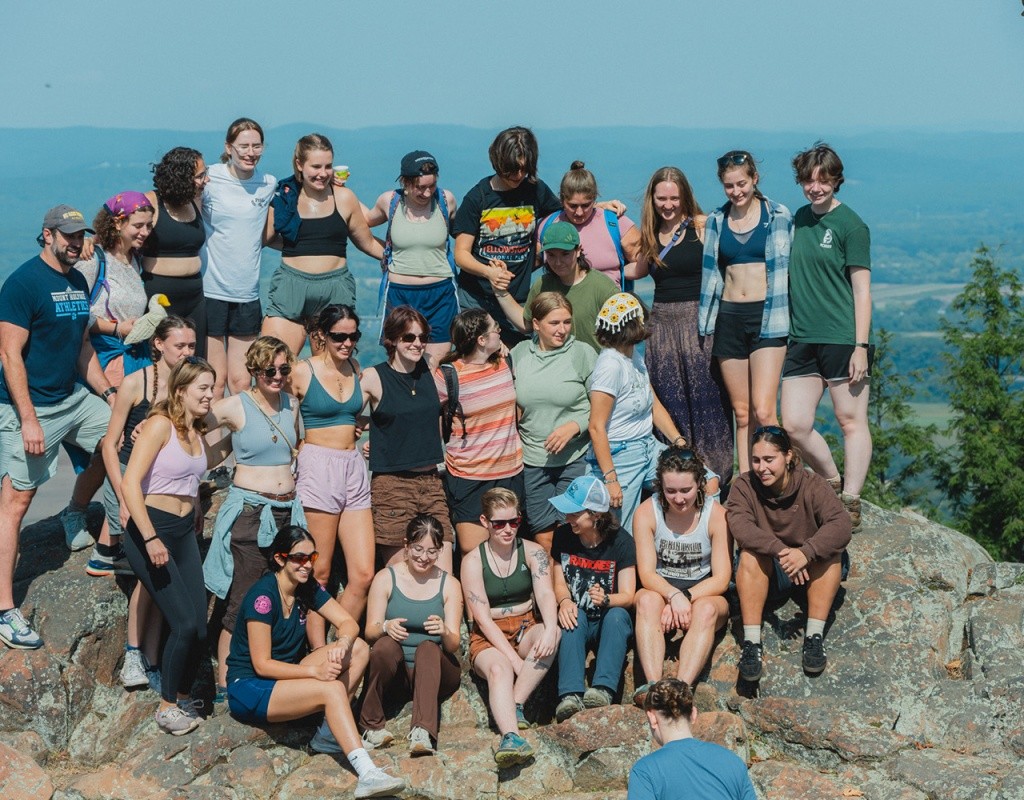 Mountain Day 2024 - A large group of students pose for photos at the top of the mountain.