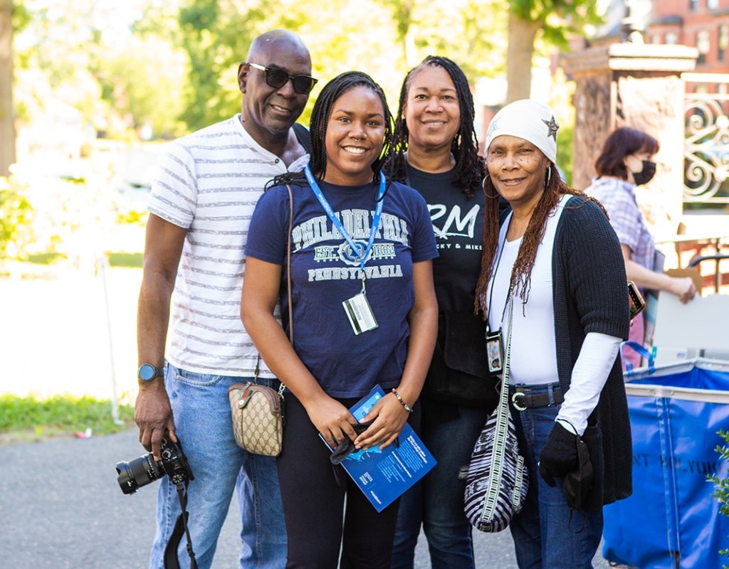 A family of four pose for a photo during move-in day, 2022